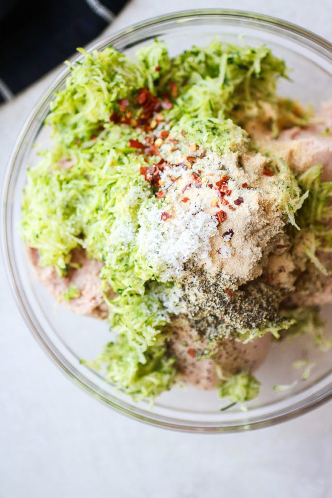Overhead view of a glass bowl filled with Italian Turkey Zucchini Meatballs ingredients