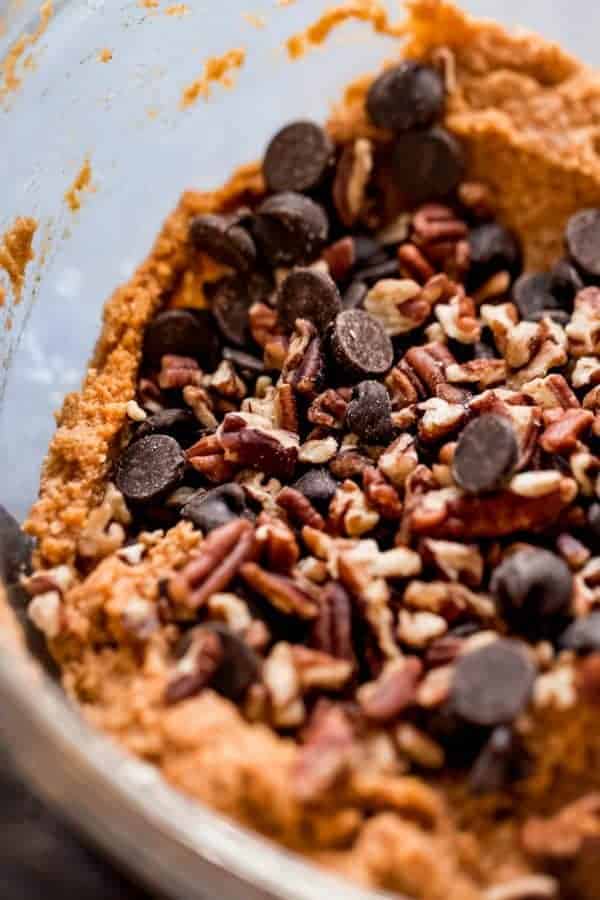 A close up view of paleo pumpkin bread batter with chocolate chips and pecans ready to be stirred in.