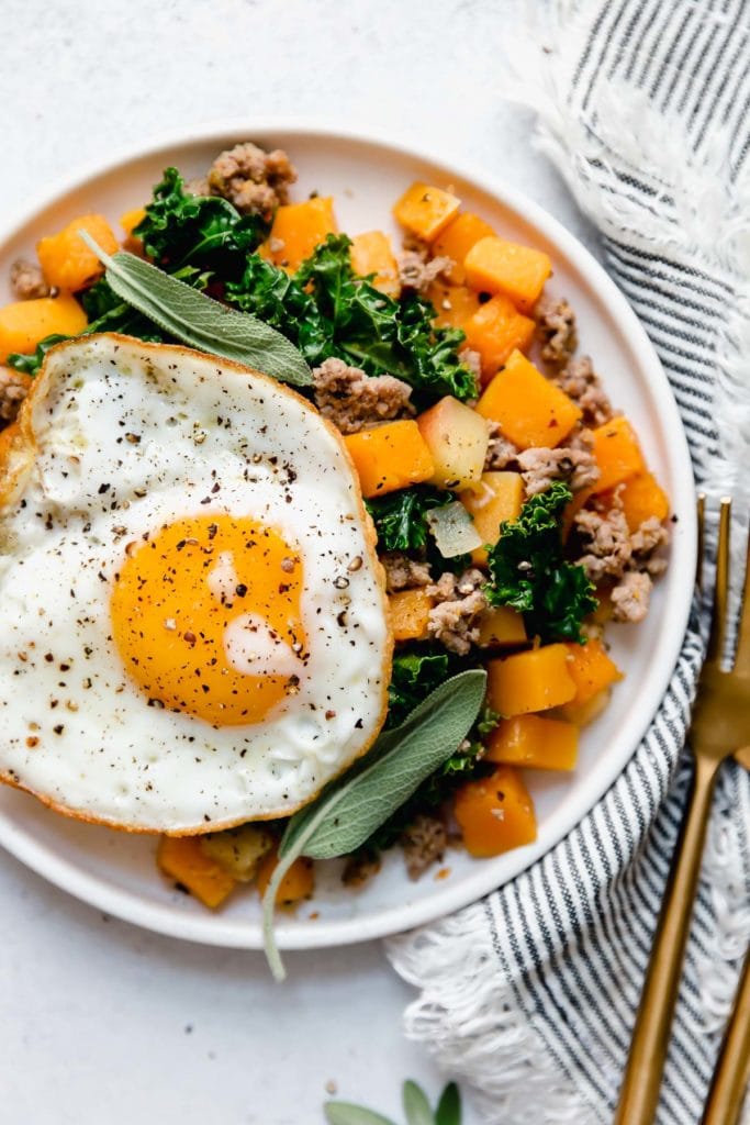 Overhead view of a plate of Butternut Squash and Apple Hash with Sausage.