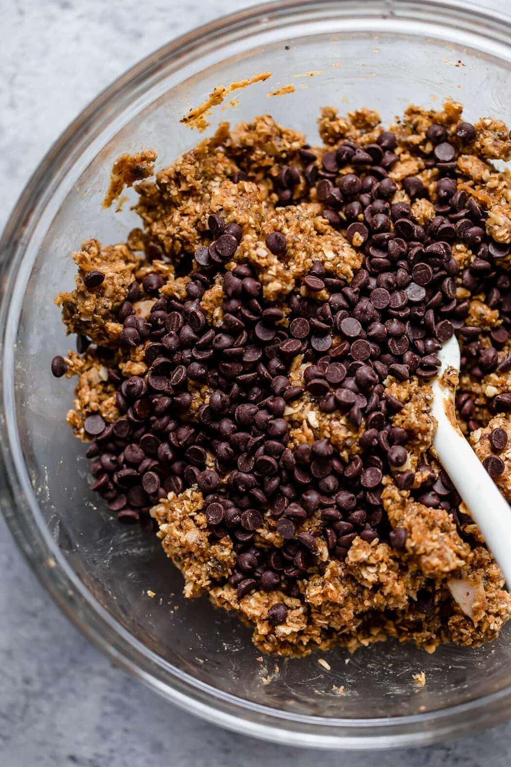 Ingredients for the Peanut Butter Oatmeal Balls in a bowl with chocolate chips.
