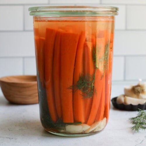 A jar of fermented carrots with dill.