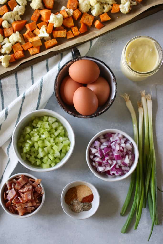Roasted Cauliflower Sweet Potato Salad ingredients arranged on a table 