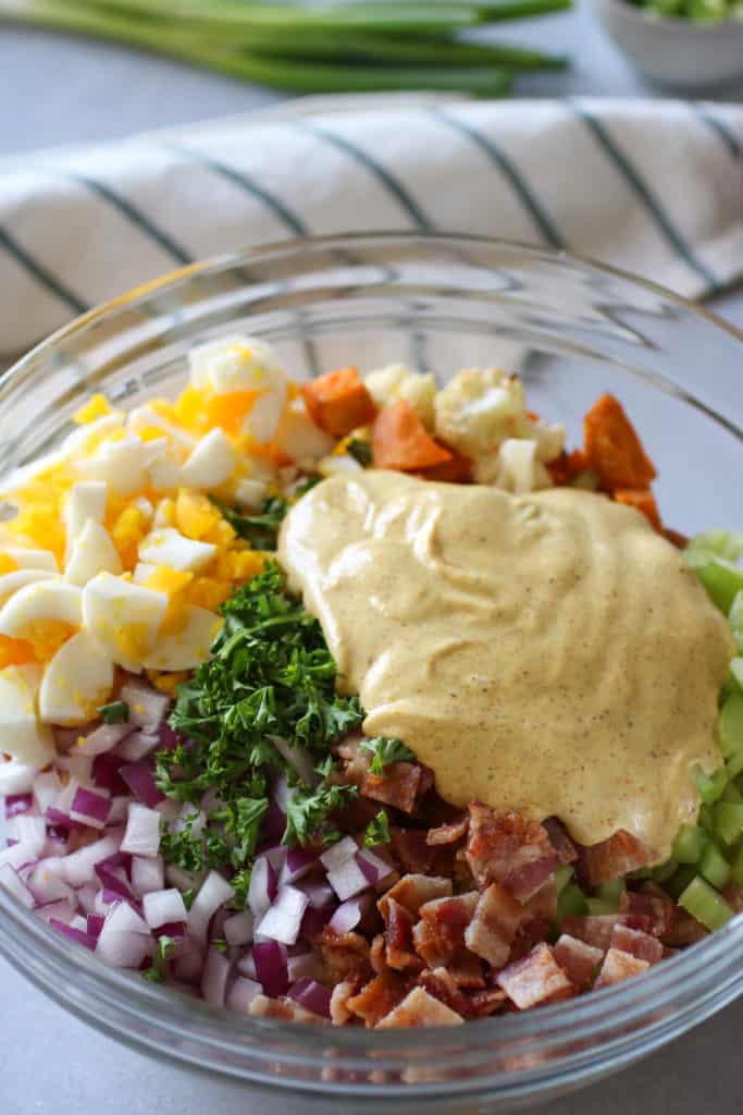Roasted Cauliflower Sweet Potato Salad ingredients in a glass bowl