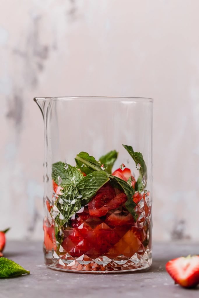 Low-Sugar Strawberry Mojito Kombucha Cocktail ingredients in a glass pitcher