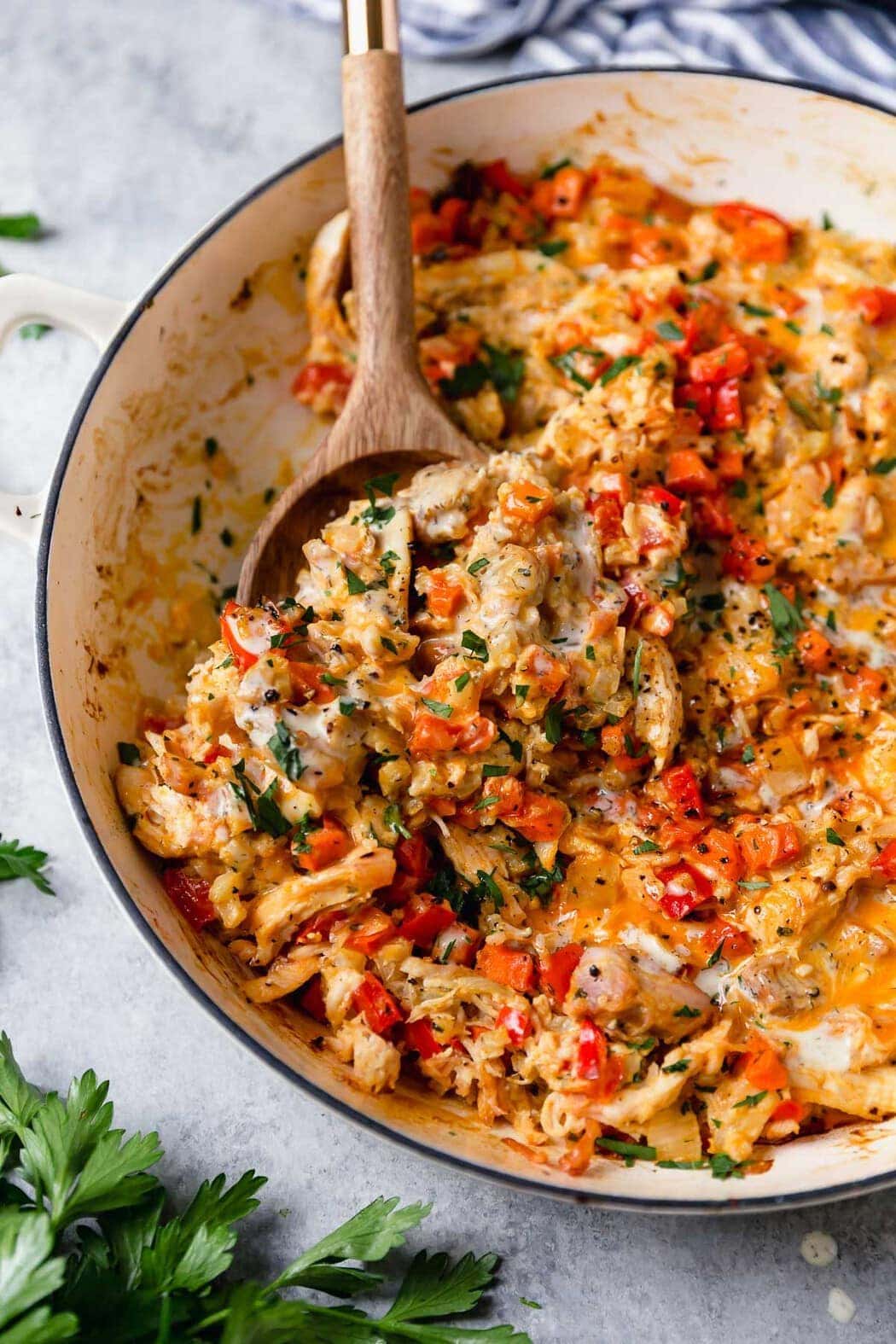 Creamy buffalo chicken veggie casserole in a white skillet