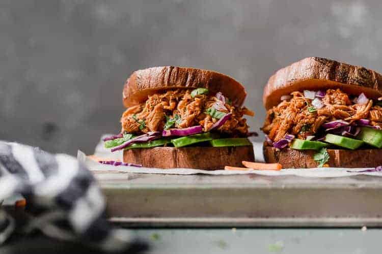 Side view slow cooker chicken sloppy joe in sweet potato bun