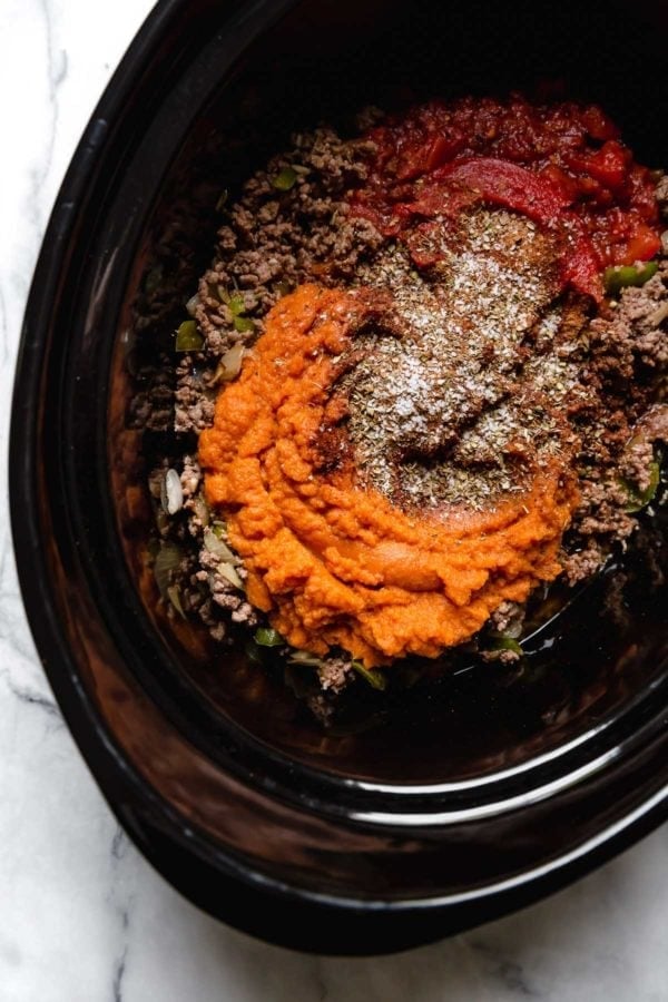 Overhead view of a slow cooker filled with Slow Cooker Pumpkin Chili ingredients