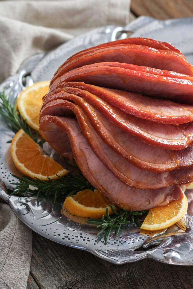 Overhead view of a spiral cut glazed ham on a platter.