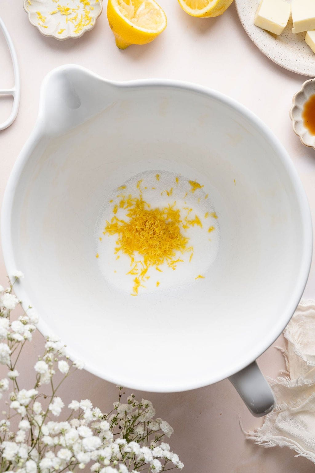 Overhead view of a white bowl filled with lemon zest. 