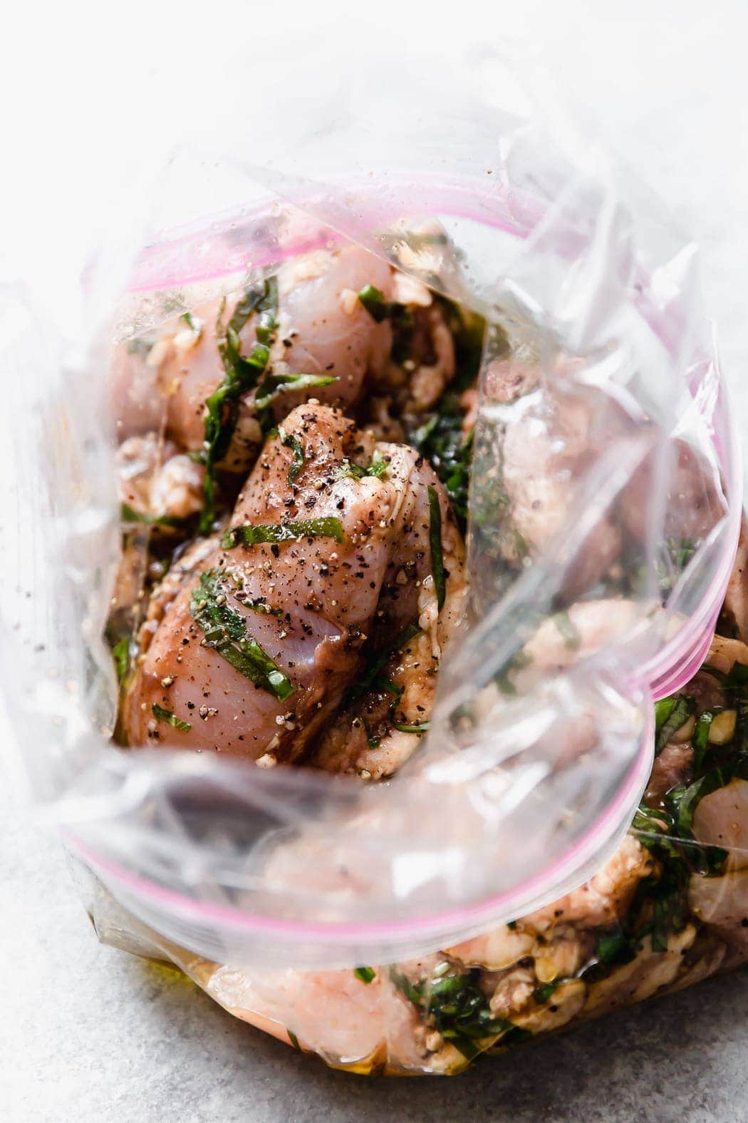 Overhead view balsamic chicken marinating in zip top bag