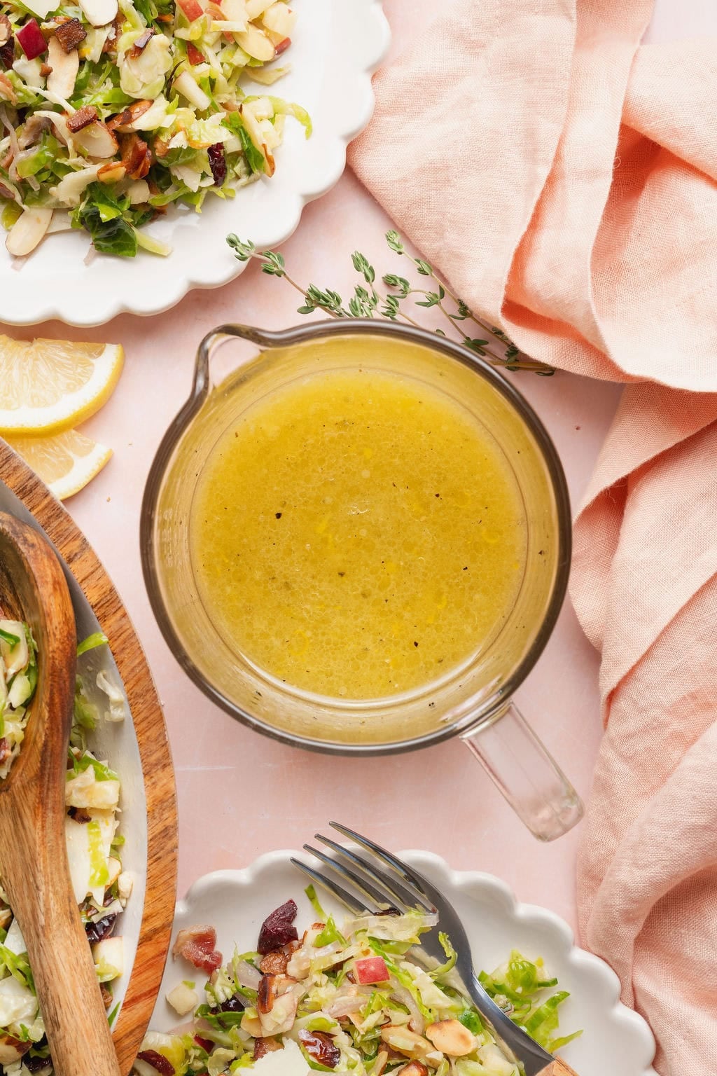 A liquid measuring cup full of citrus vinaigrette dressing.
