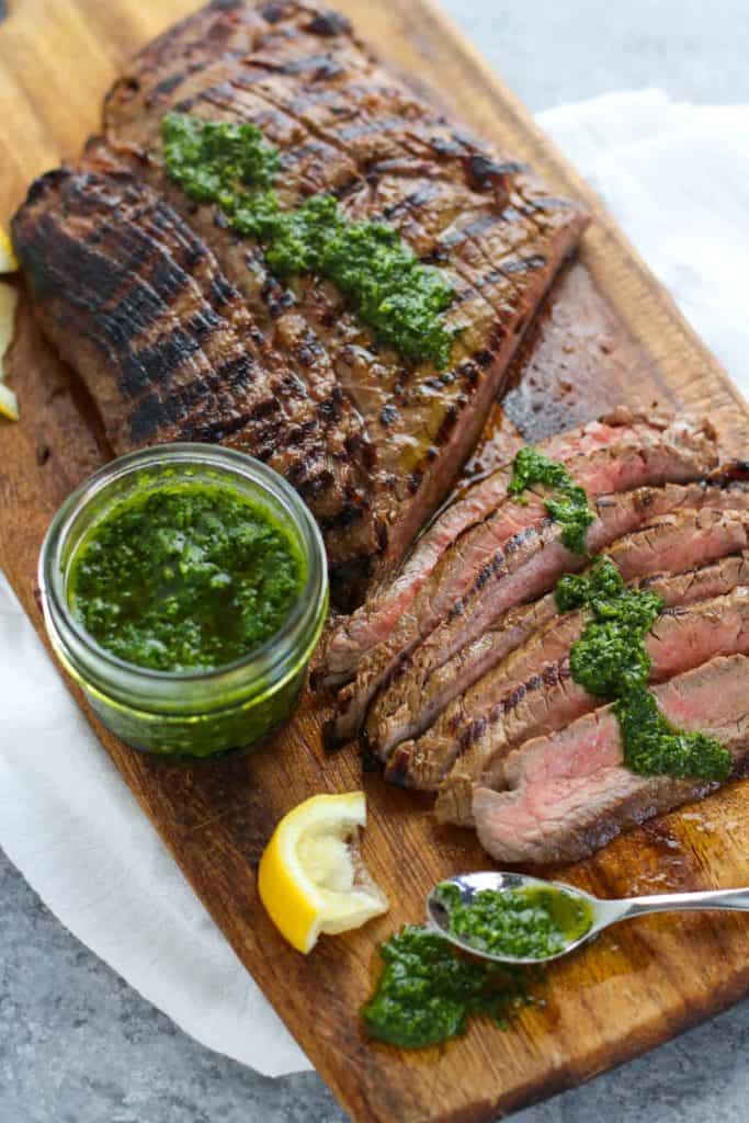 thinly sliced Balsamic Flank Steak with Chimichurri Sauce drizzled over