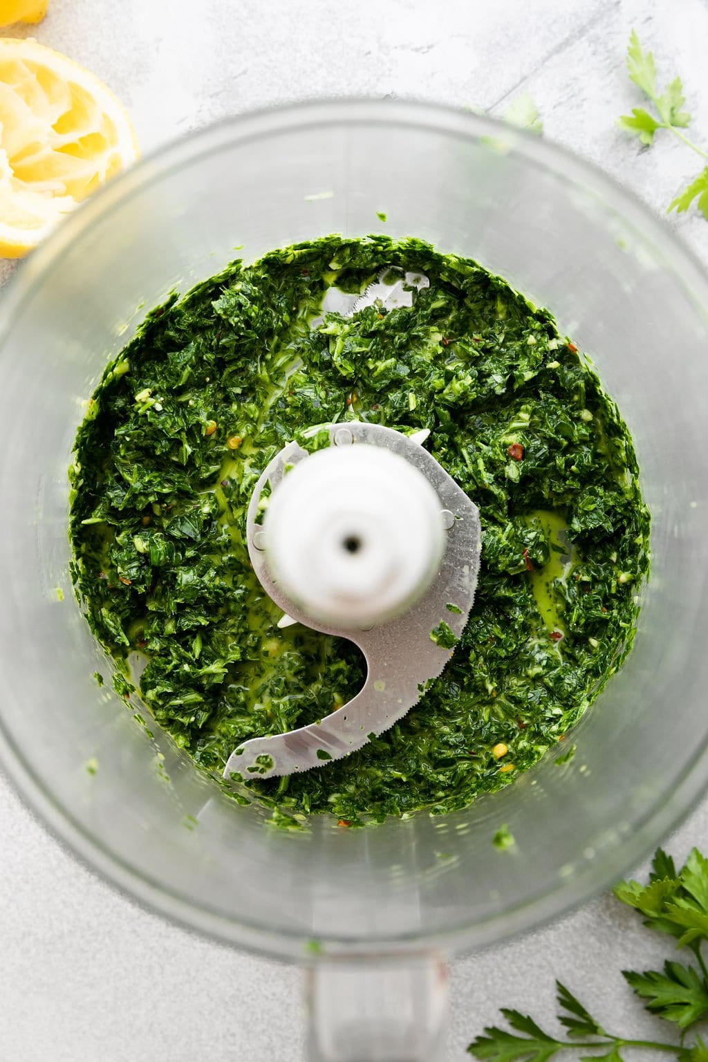 Homemade chimichurri sauce in food processor bowl. 