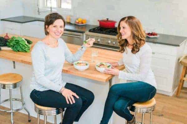 Two women enjoying a meal at a kitchen island