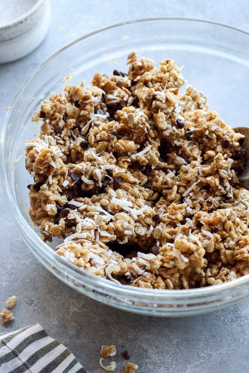 Homemade chocolate chip clif bar mixture being stirred in a mixing bowl