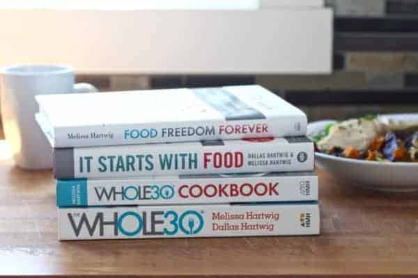 A stack of books about Whole30