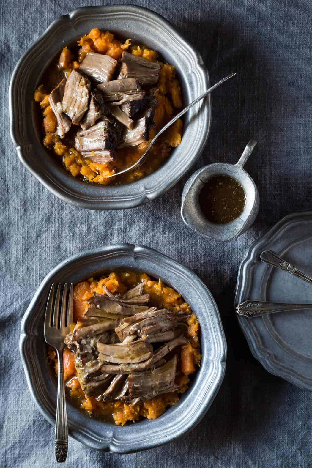 Aerial view of Slow Cooker pot roast in silver bowls