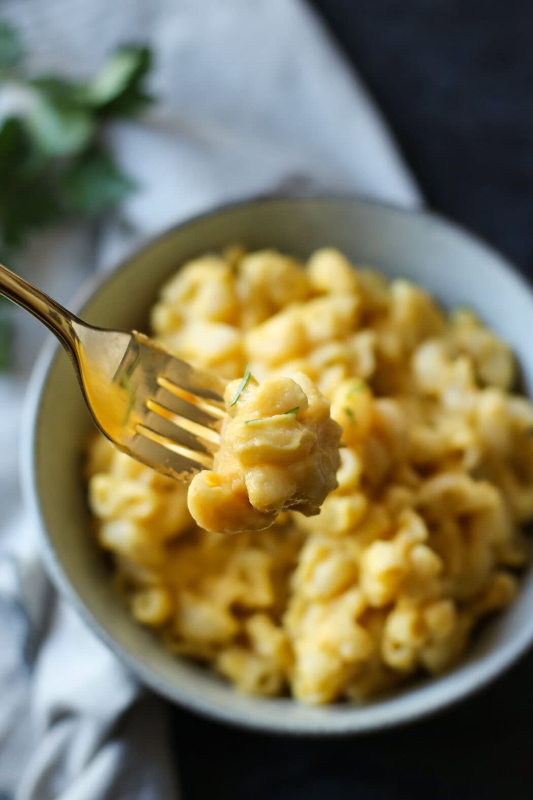A close up of dairy-free Mac and cheese on a gold fork.
