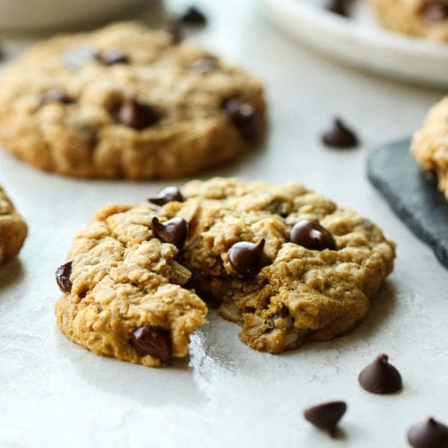 A peanut butter oatmeal cookie broken in half to show the soft and chewy texture