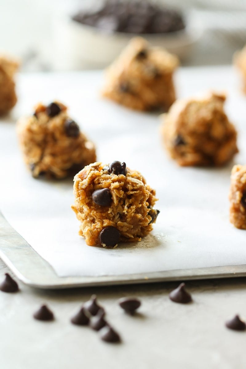 Round cookie dough balls on a baking sheet ready for the oven