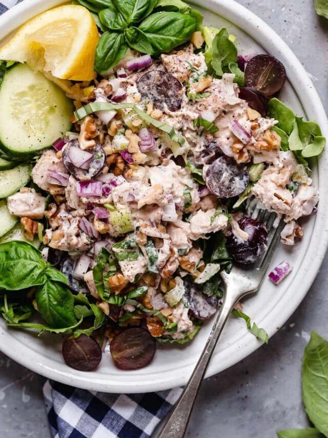 Classic Waldorf Chicken Salad on a white plate, a fork on the side. 