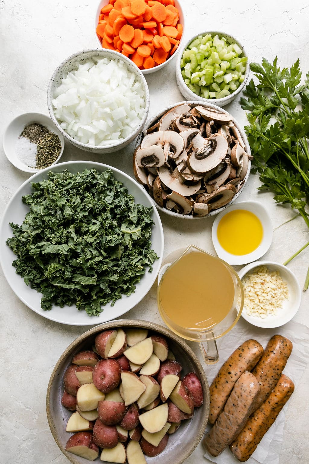 All ingredients for harvest Italian soup with sausage arranged in small bowls.