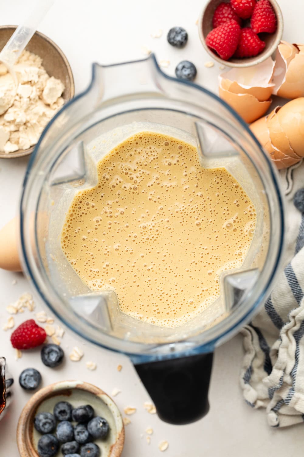 Overhead view of a blender filled with freshly blended Protein Waffles ingredients. 