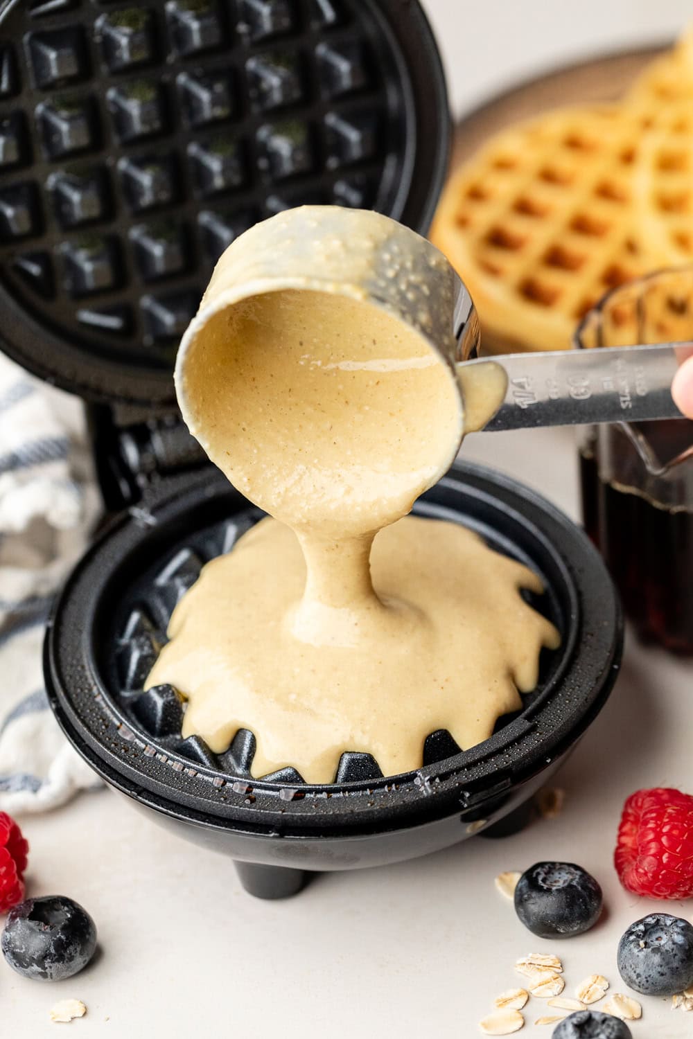 Close up view of Protein Waffles batter being poured into a waffle iron. 