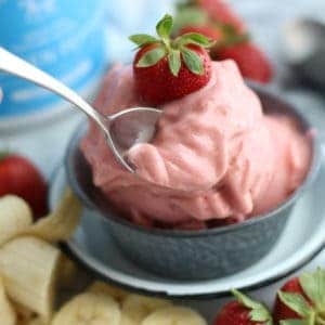 Strawberry banana homemade ice cream blended and topped with a strawberry