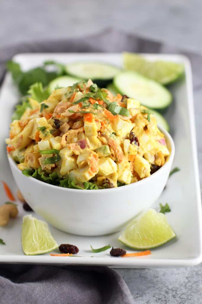 Close up view of a white bowl filled with Curry Egg Salad