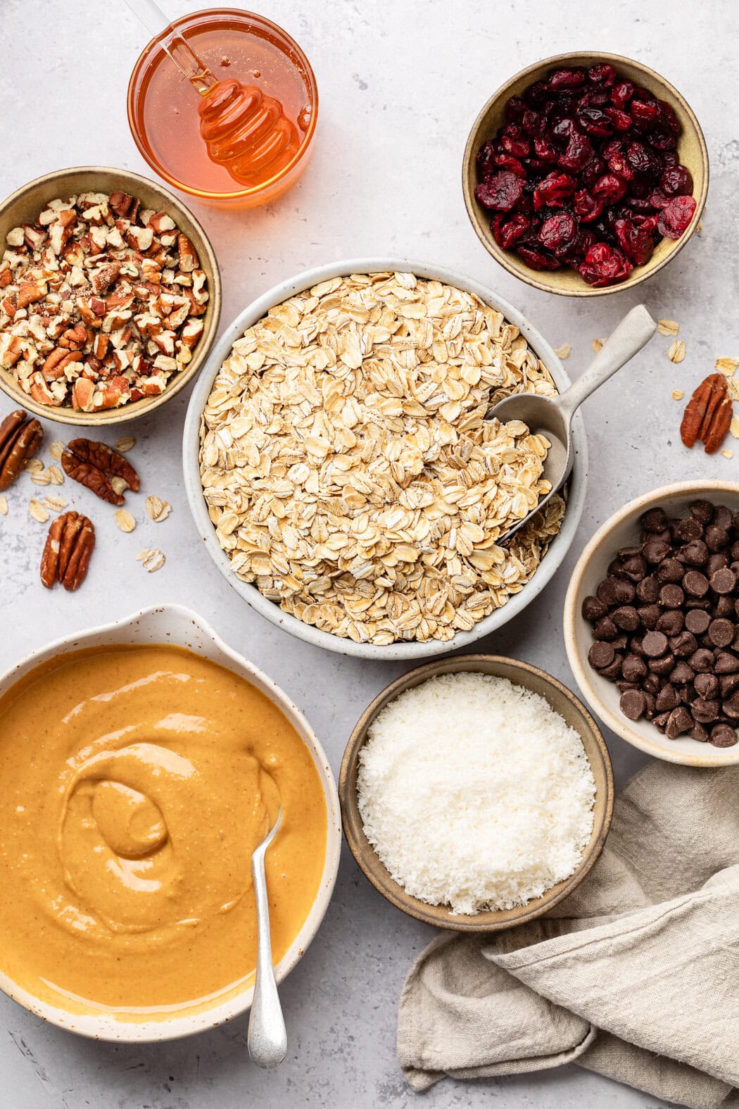 Overhead view of a variety of ingredients for Trail Mix Granola Bars in different sized bowls. 