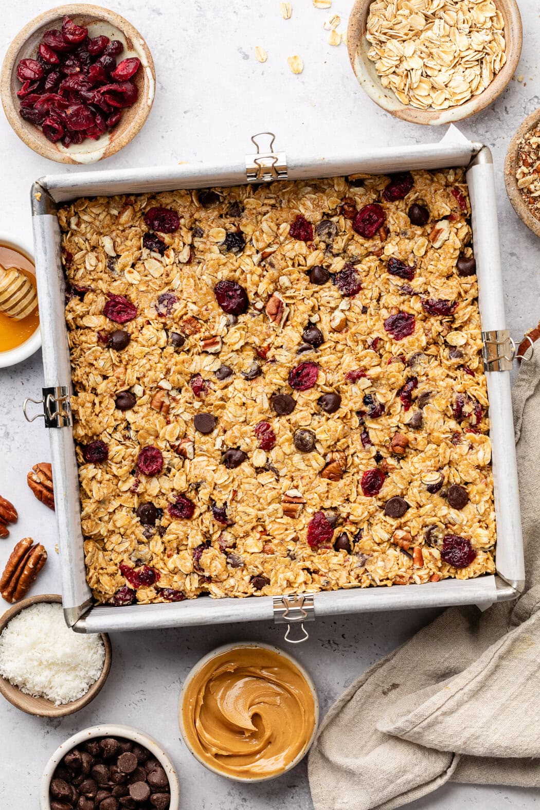 Overhead view of a pan filled with Trail Mix Granola Bar mixture ready for the freezer for setting. 