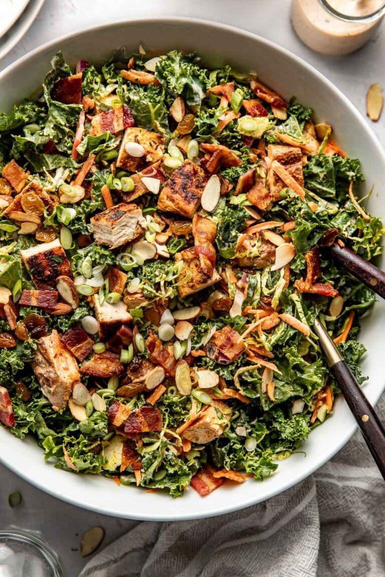 Overhead view of a colorful Chopped BBQ Ranch Chicken Salad topped with toasted almonds and green onions.