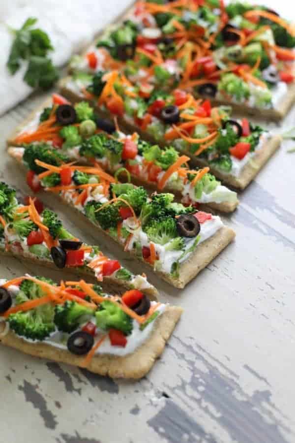 Gluten-free Veggie Pizza cut in slices on a table top