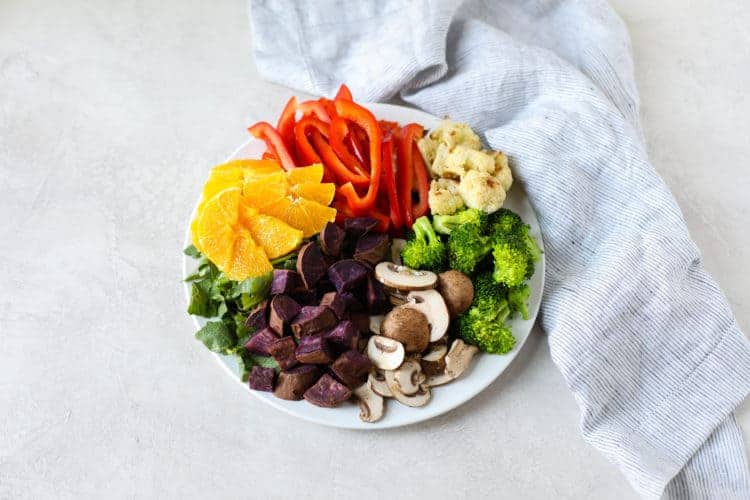 Overhead view of a plate filled with colorful fruits and vegetables