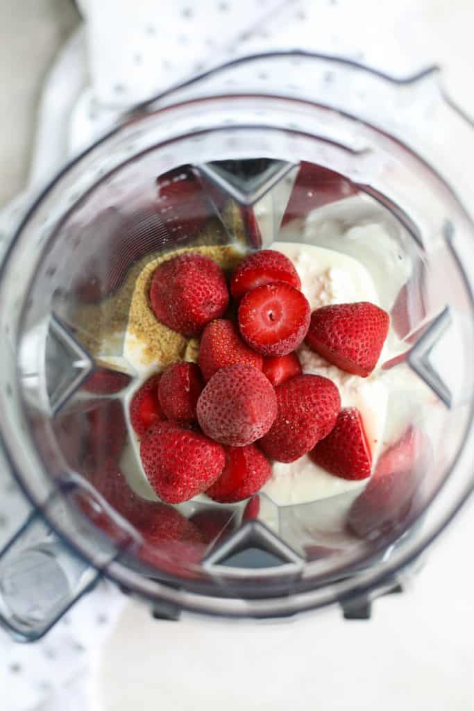 Strawberry Cheesecake Smoothie ingredients in a blender ready for blending