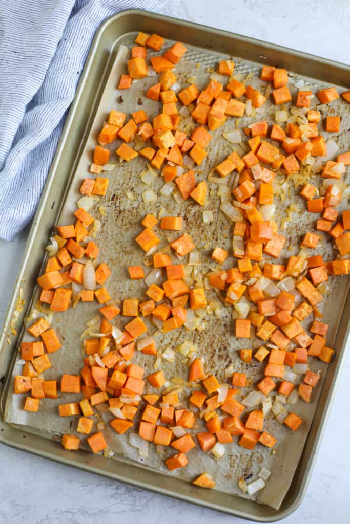 Sheet pan filled with diced sweet potatoes