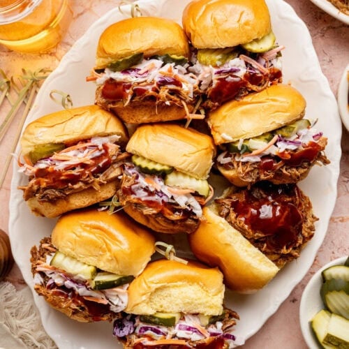 Overhead view of a platter of Pulled Pork Sliders topped with coleslaw
