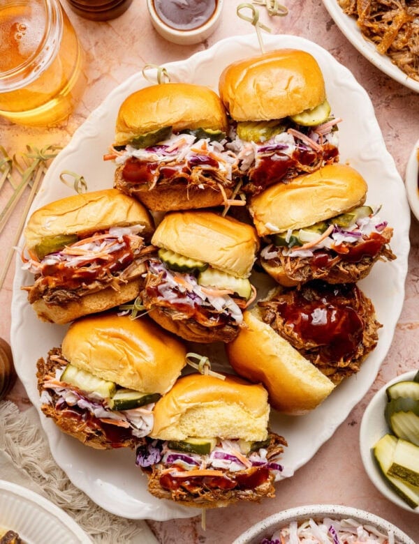 Overhead view of a platter of Pulled Pork Sliders topped with coleslaw