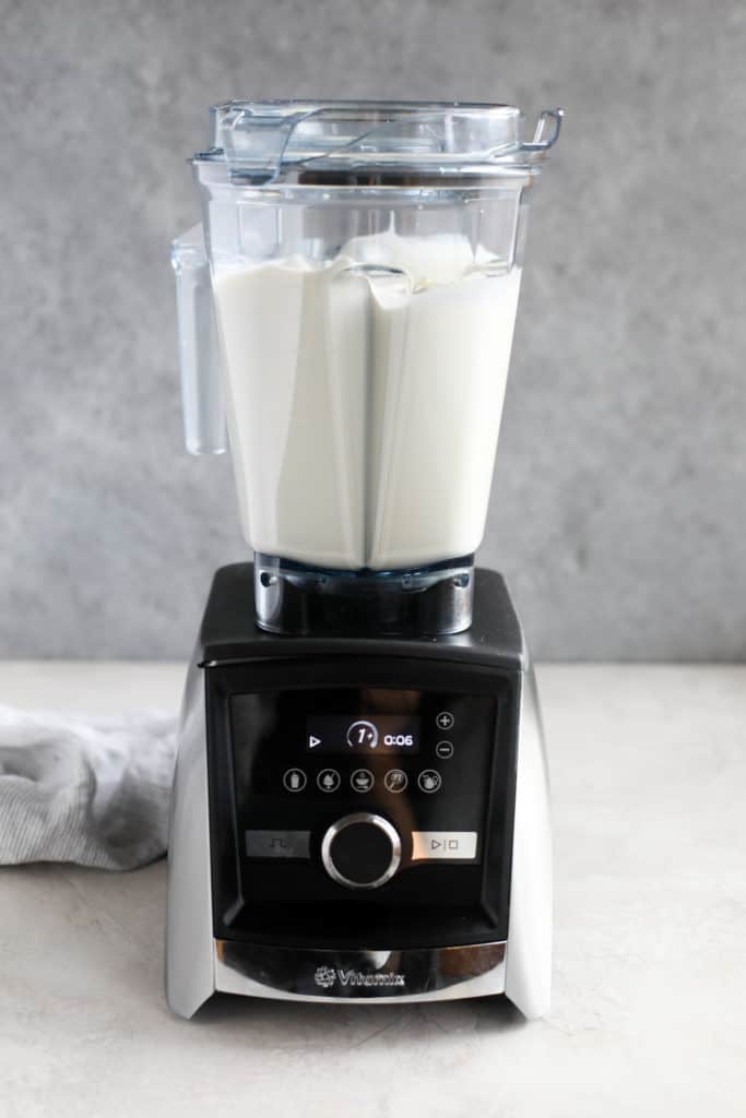 Side view of a blender filled with cream