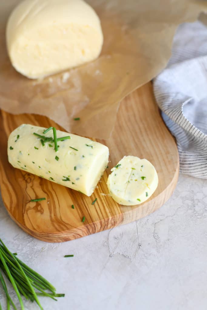 A fresh log of butter with fresh herbs in it