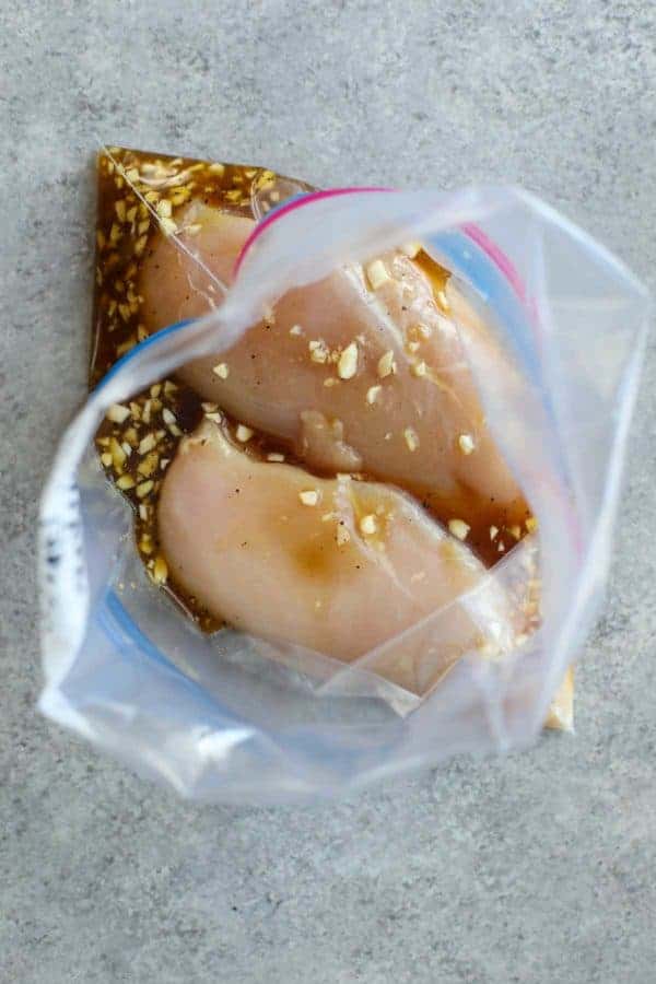 Overhead view of a bag of chicken breasts marinating. 