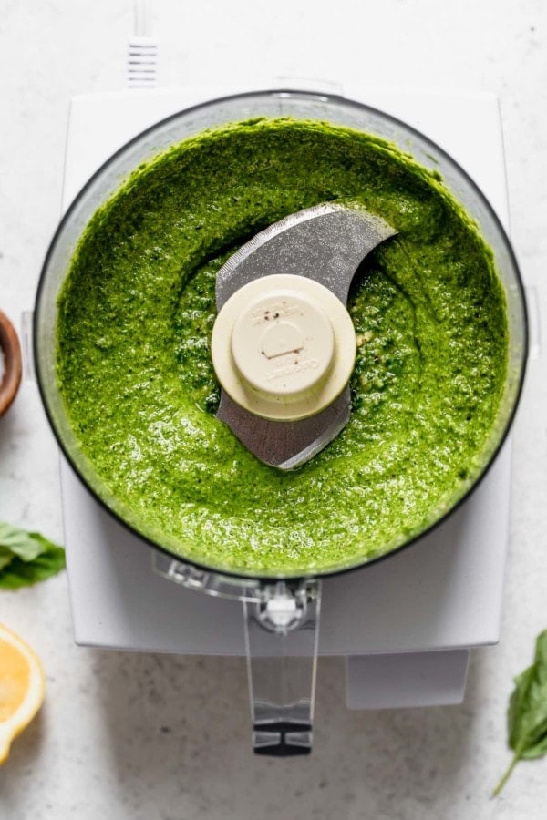 Overhead view of basil walnut pesto in a food processor