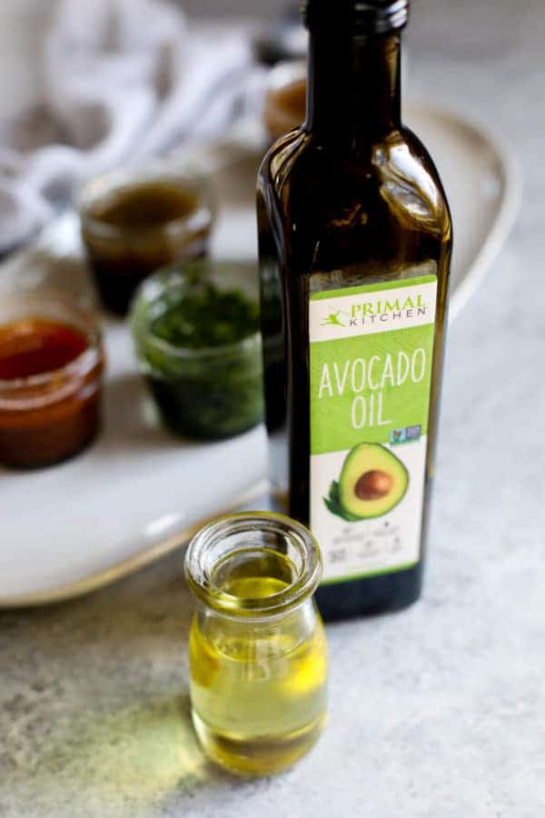 close up view of avocado oil in a small glass bottle