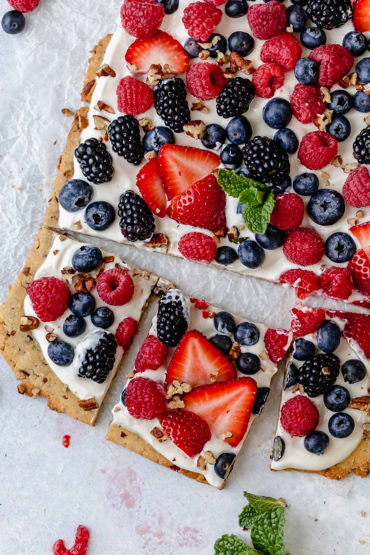 Overhead view berry fruit pizza cut into squares
