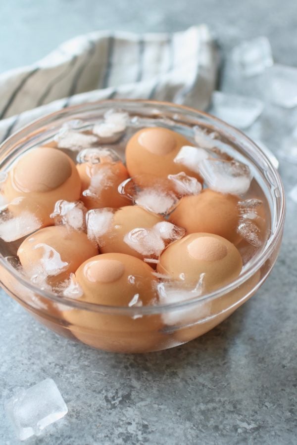A glass bowl of ice water filled with Hard-Boiled Eggs
