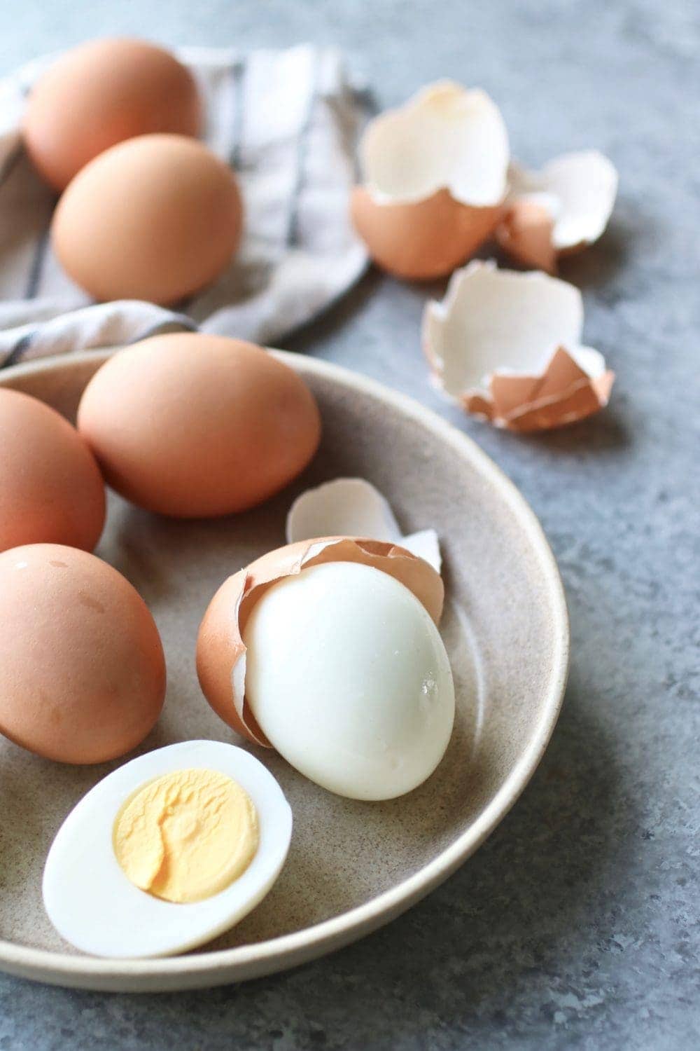 A dish filled with Hard-Boiled Eggs and eggshells