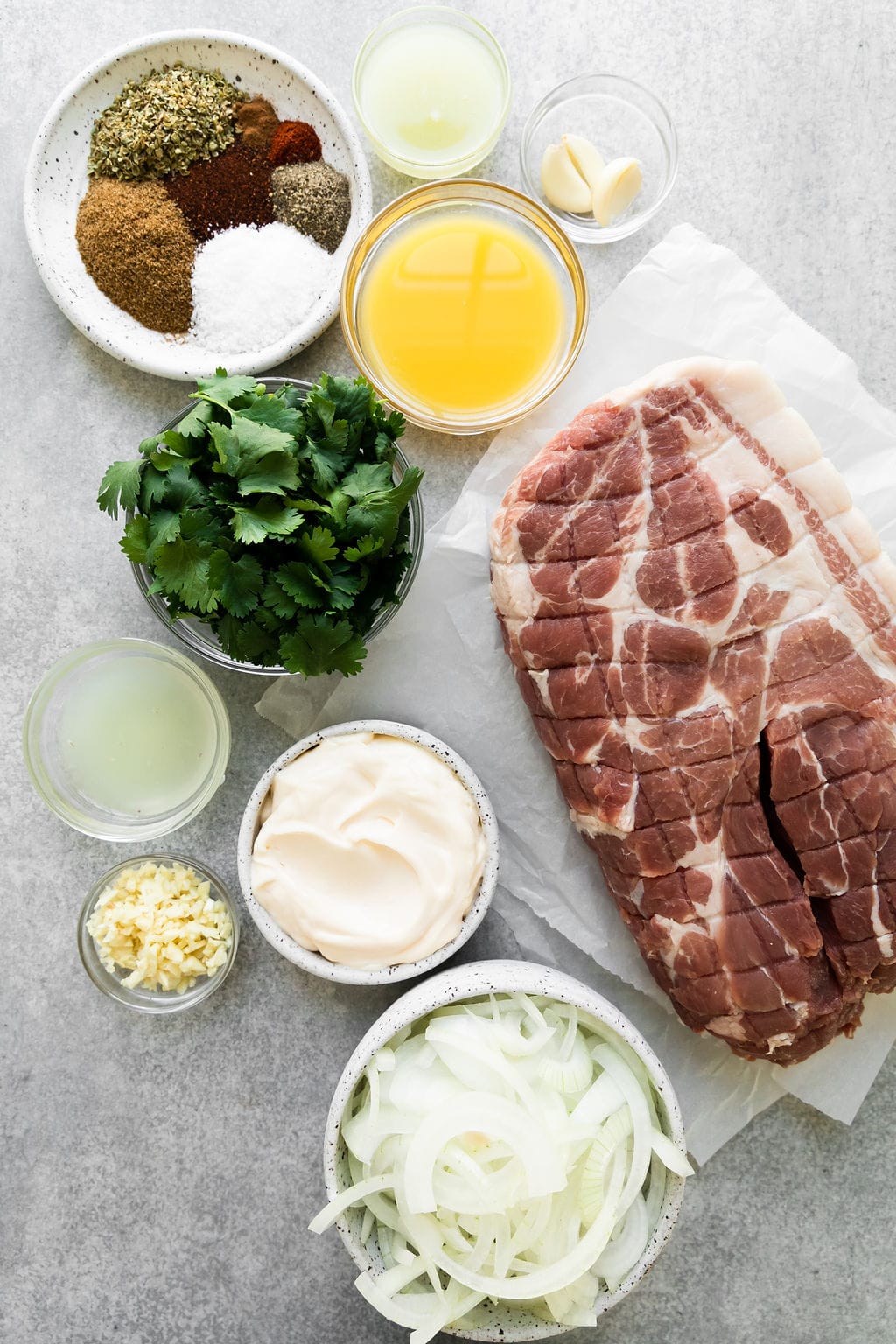 All ingredients for slow cooker carnitas arranged together on a counter. 