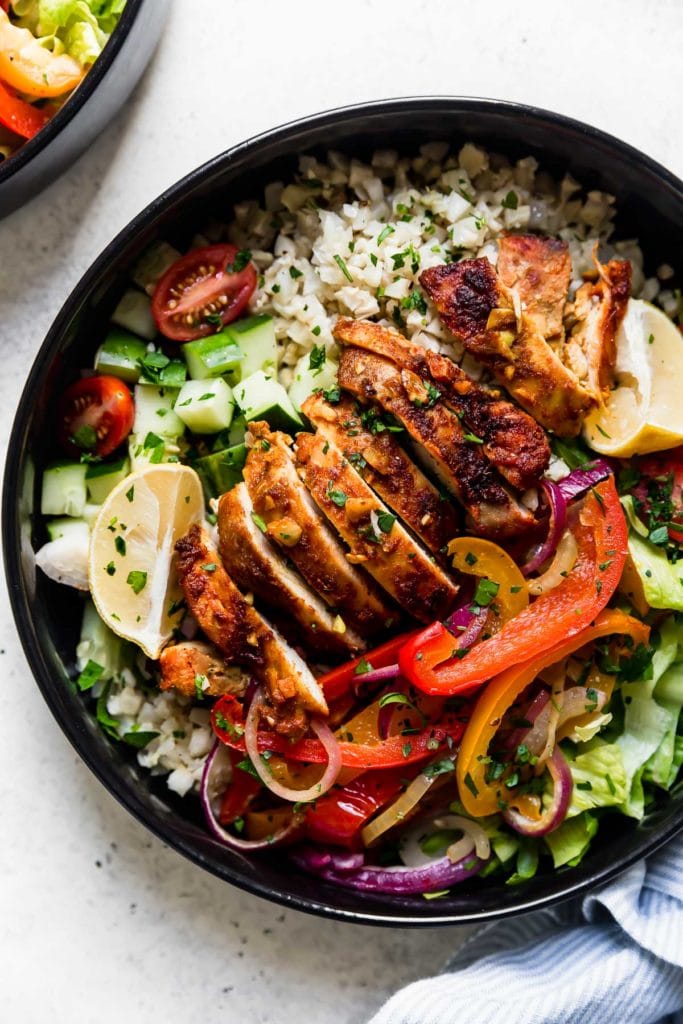 Close up view of a plate of Easy Sheet Pan Chicken Shawarma Bowls with Veggies
