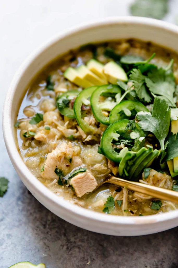 Slow Cooker Chicken Chile Verde Stew in a white bowl topped with jalapeno